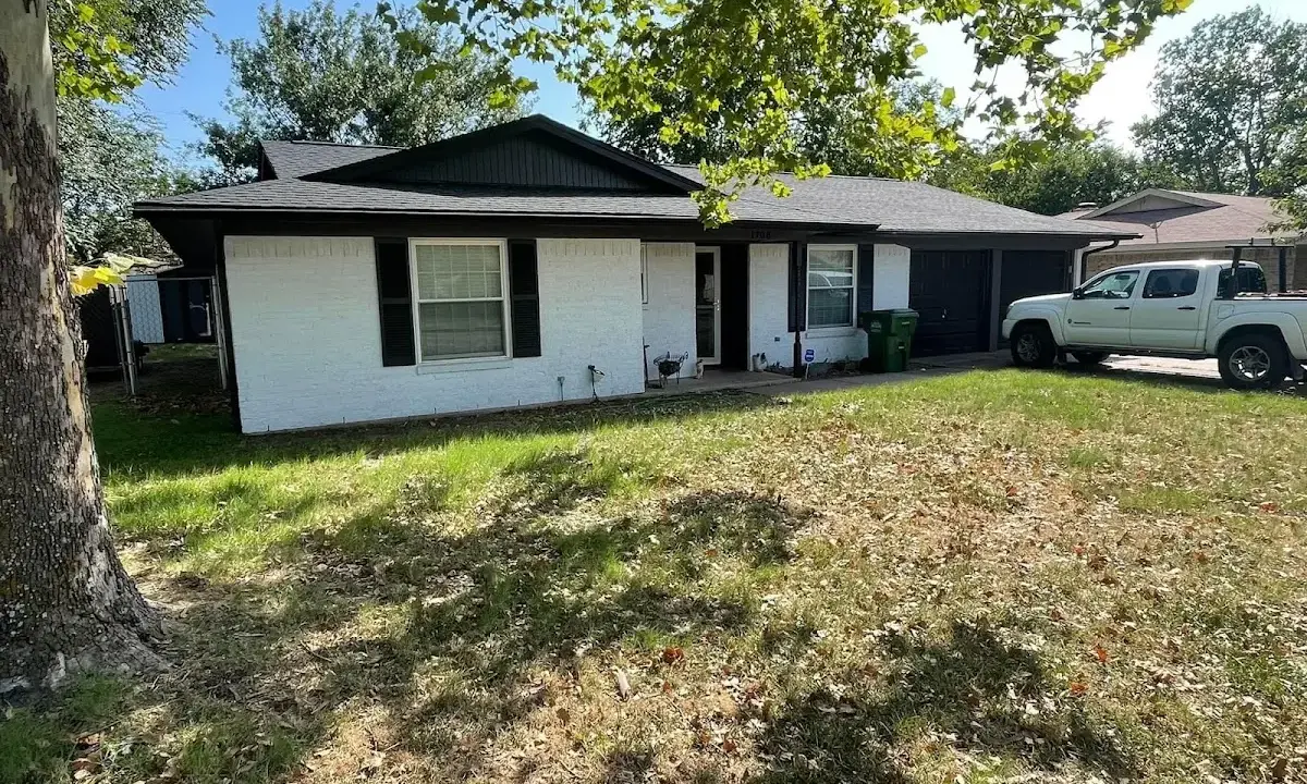 Professional roofing crew working on a residential roof in Wasco